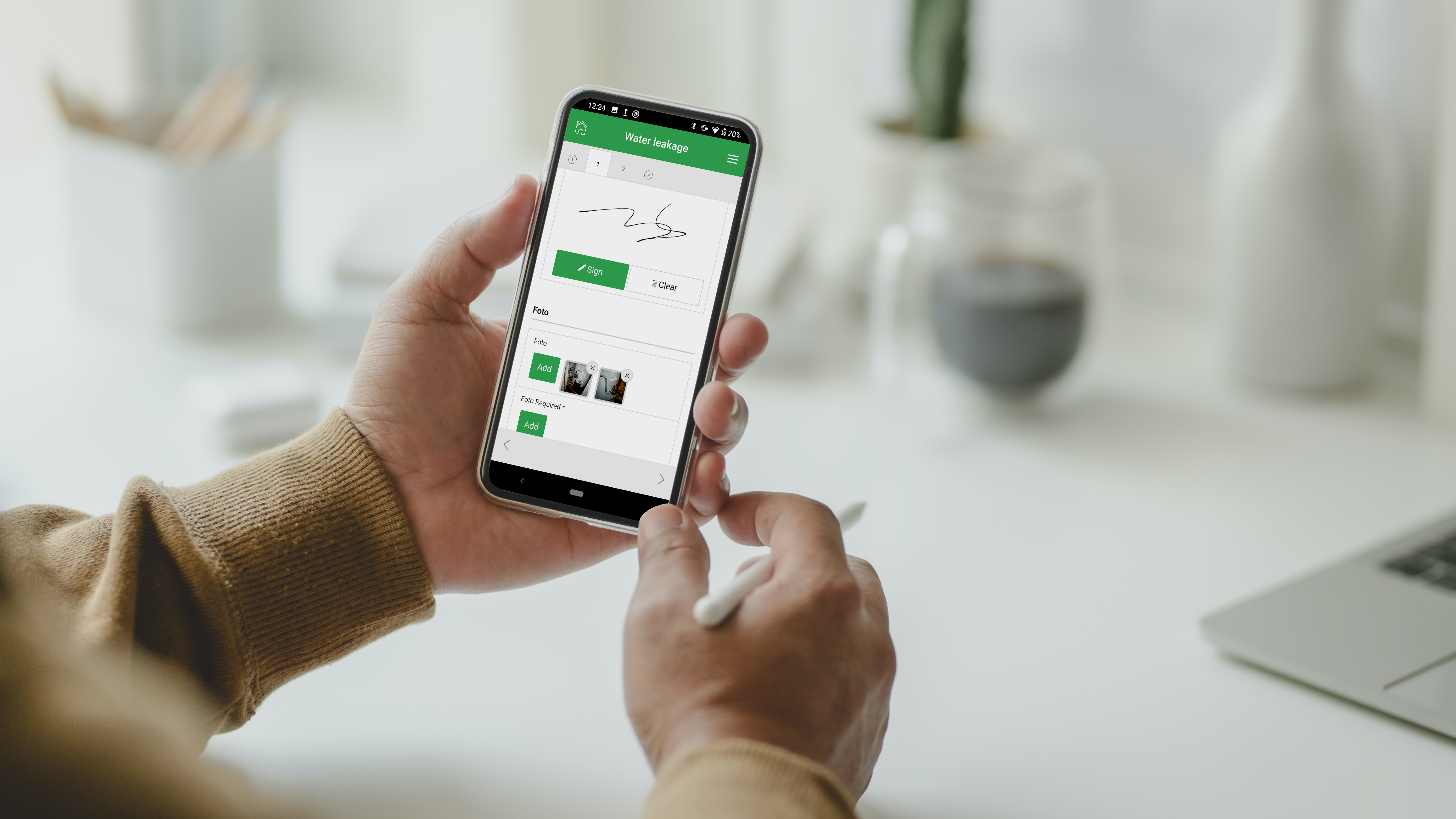 person-holding-stylus-and-mobile-phone-MF2